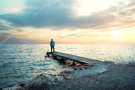 Solitary Man Stand On Boardwalk Observing The Sea Stock Photo By