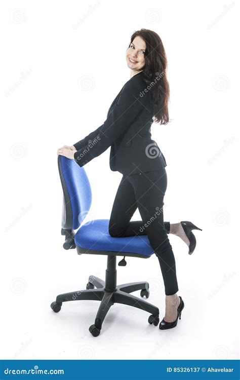 beautiful brunette secretary poses with one leg on office chair stock image image of lady