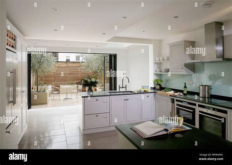 Central Island Unit In Modern Kitchen With White Units Stock Photo Alamy