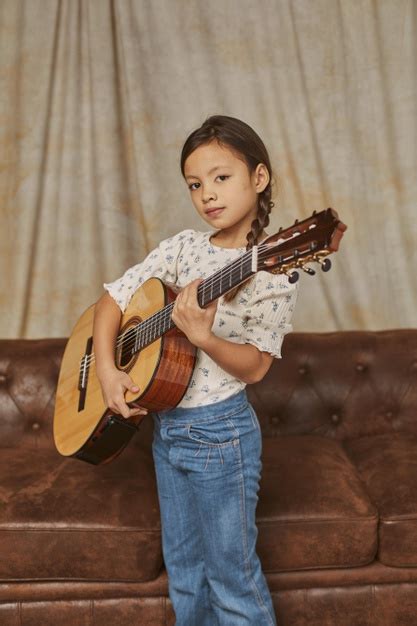 Freepik - Young girl playing guitar at home Free Photo ...
