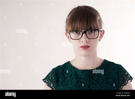 Head And Shoulder Portrait Of Young Woman Wearing Horn Rimmed Eyeglasses Looking At Camera