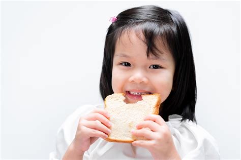 Happy Child Eat Slices Of Bread Simple Breakfast Isolated White