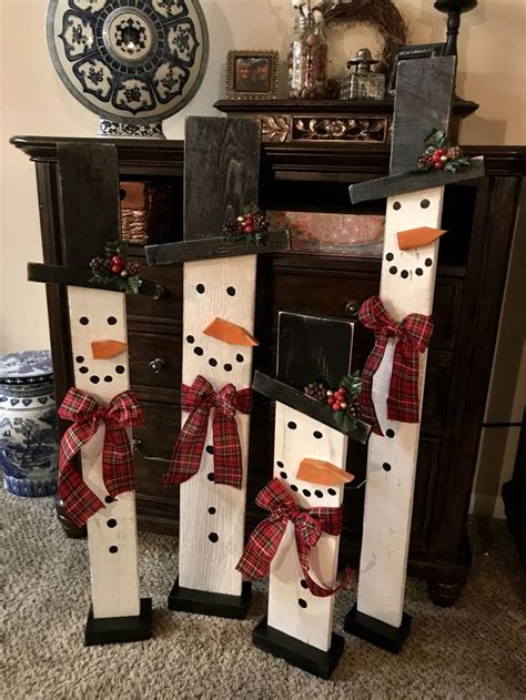 Three Snowmen Are Standing Next To Each Other In Front Of A Fireplace