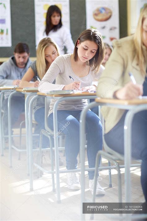 Cropped Portrait Of Students In Classroom Having An Exam — Desks