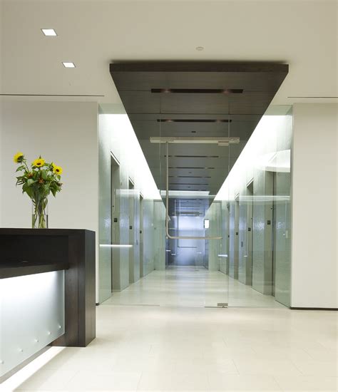 Modern Elevator Lobby Design With Dark Ceiling And Black Lobby Island