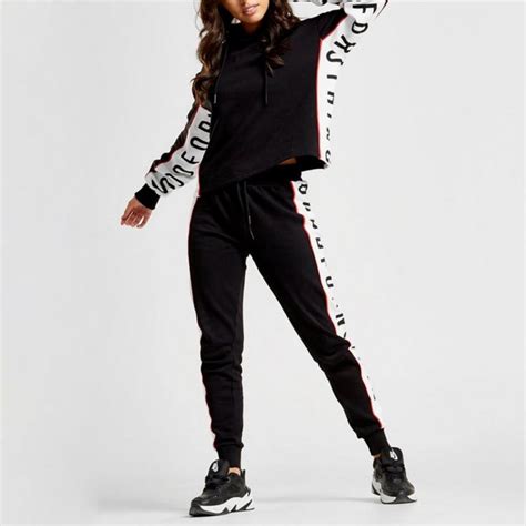 womens custom tracksuits with branding details to the sides fully custom hats and garments