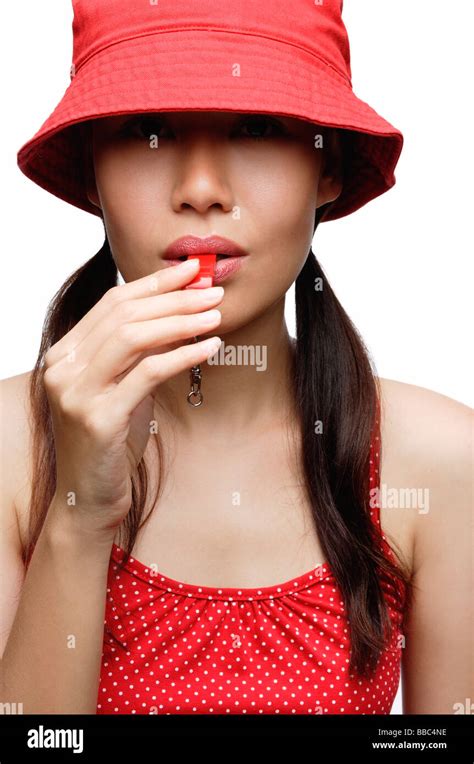 Girl In Red Blowing Whistle Stock Photo Alamy