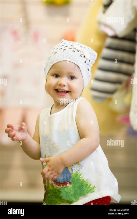 The Little Baby Girl Dancing In Clothes Store Stock Photo Alamy