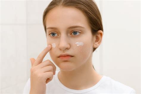 Girl Puts Cream On Her Face Face Of A Teenage Girl With Good Skin She