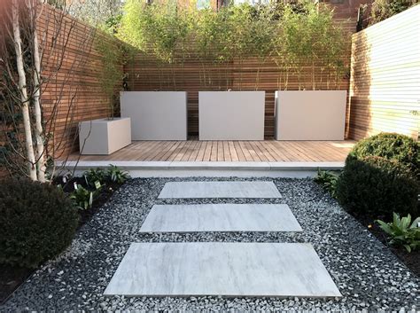 Most professional garden designers have some training in horticulture and the principles of design. Modern contemporary garden design London balau decking jasmine living wall - London Garden Design