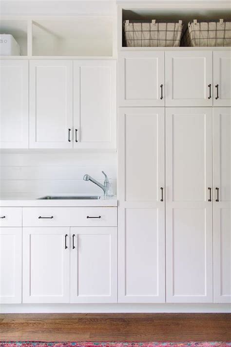 But the versatility of the common pantry grows when. White Laundry Cabinets with Shiplap Backsplash ...