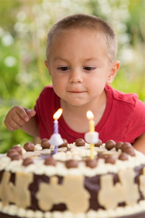Boy Blowing Out Candles Free Stock Photo Public Domain Pictures