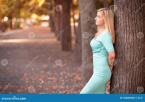 Portrait Of Young Woman Leaning Against A Tree Stock Image Image Of Caucasian Fall 158409369