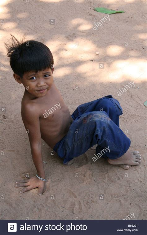 Photograph Of A Cute Cambodian Boy Playing Near A Temple In Siem Reap