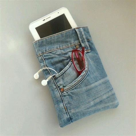 A Cell Phone In A Jeans Pocket With Earbuds Attached To The Back Side