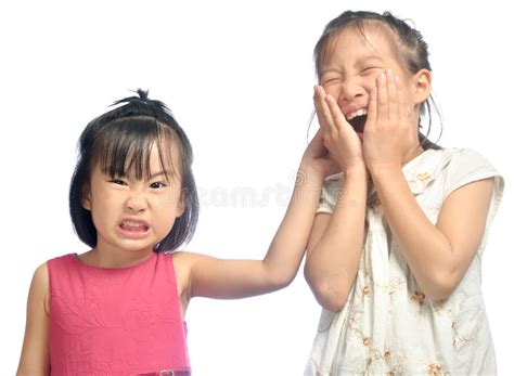 Siblings Teasing Asian Little Girl Pulling Her Sister S Ear Stock