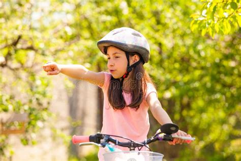Girl Riding On The Bike Outdoor And Shows The Trail Stock Image Image