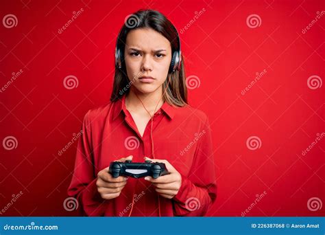 Young Beautiful Brunette Gamer Girl Playing Video Game Using Joystick