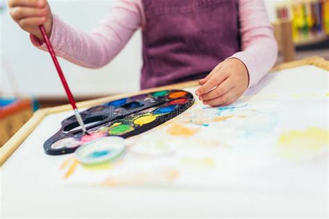 Happy Little Girl Preschooler Painting With Water Color Stock Photo