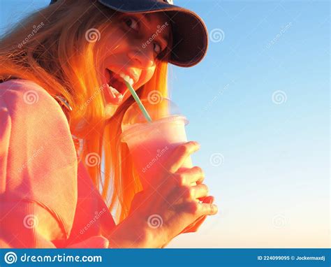 Girl With Bulging Eyes And Opening Her Mouth Holds A Glass With A Milky