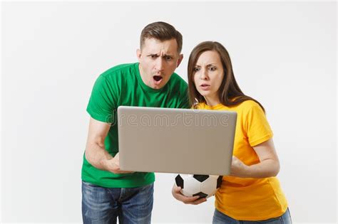 shocked couple woman man football fans in yellow green t shirt cheer up support team with
