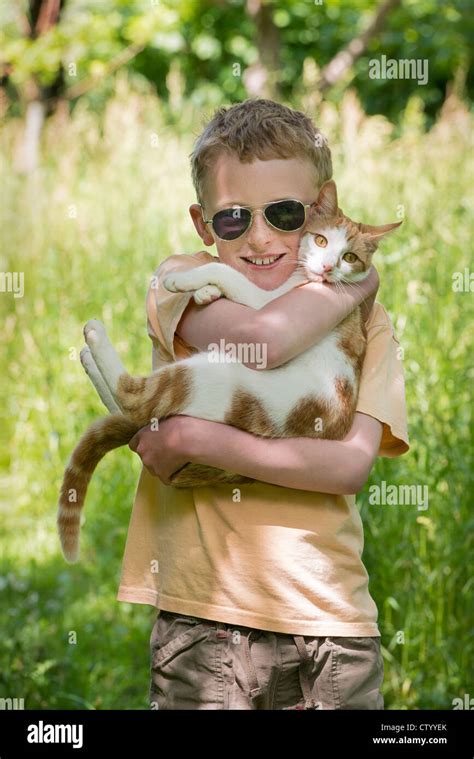 Boy Carrying Cat Outdoors Stock Photo Alamy