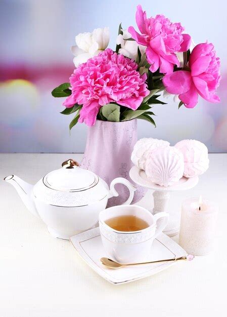 Premium Photo Composition Of Beautiful Peonies In Vase Tea In Cup And Marshmallow On Table