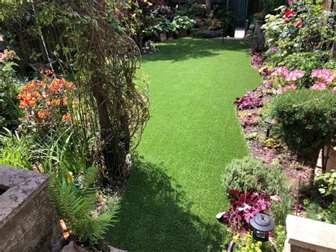 Gray stone pavers with grass or artificial grass. How to install artificial grass on paving bricks | Perfect Grass Ltd