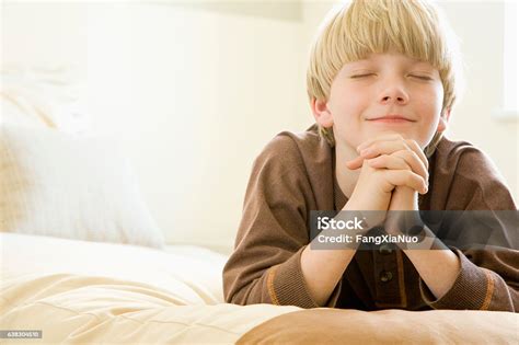 Boy Praying Alone At Home In Bedroom Stock Photo Download Image Now