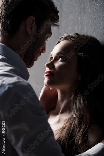 Young Sensual Couple Able To Kiss While Standing Near The Wall Stockfotos Und Lizenzfreie