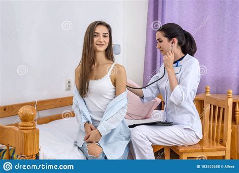 Doctor In Hospital Listening Patient`s Breathing On Back With