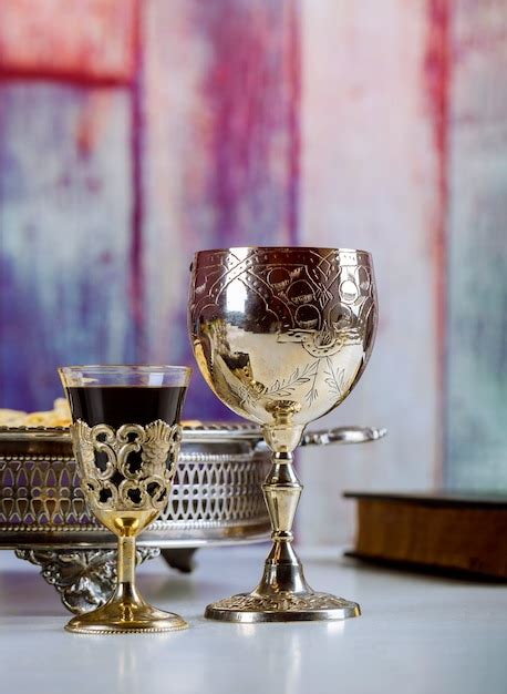 Premium Photo Taking Communion Cup Of Glass With Red Wine Bread On