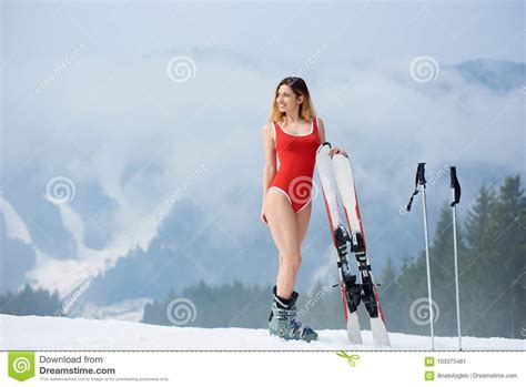 Woman Skier With Skis On Snowy Slope At Winter Ski Resort Stock Image