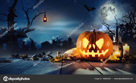 Spooky Halloween Pumpkin On Wooden Planks Stock Photo By ©jagcz 168962020