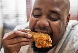 Free Photo | Man eating a piece of fried chicken