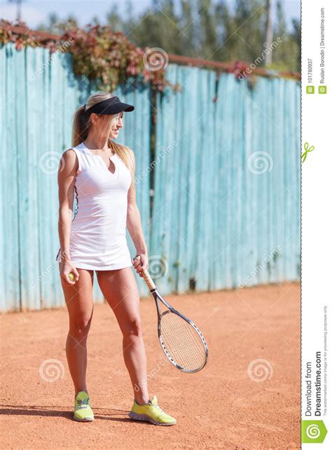 Beautiful Sports Girl With A Tennis Racket In Her Hands In A Black Cap