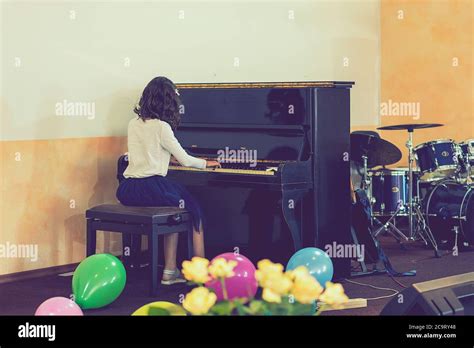 Teenage Girl Playing The Piano On Stage Toned Stock Photo Alamy