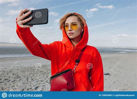 beautiful girl in red hoodie taking selfie on beach saint michaels stock image image of