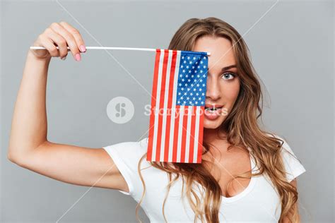 Smiling Playful Young Woman Covered Her Eye With Flag Of America Over