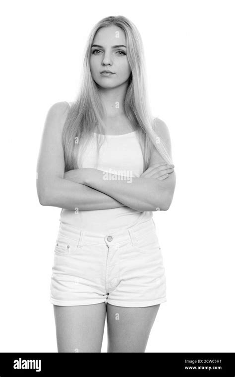 Studio Shot Of Young Beautiful Teenage Girl Standing With Arms Crossed