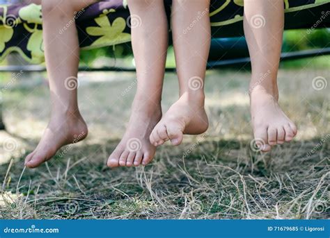 Outdoor Picture Of Two Children Legs Barefoot Closeup Of Happy Kids