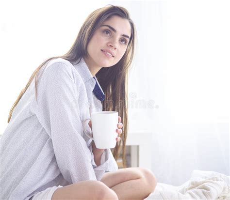 Young Beautiful Happy Brunette Woman In Black Silk Dressing Gown Lying
