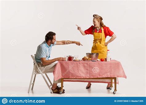 Portrait Of Young Emotive Couple Quarreling While Breakfast Isolated Over White Background Stock