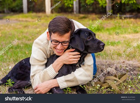Young Man Hugging Black Labrador Park Stock Photo 352476965 Shutterstock