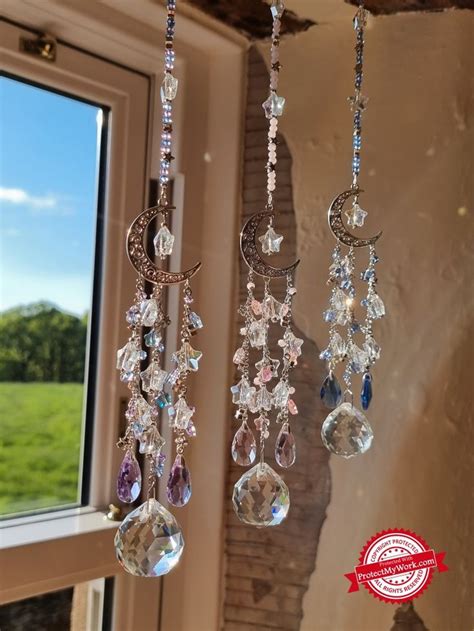 Three Crystal Chandeliers Hanging From A Window