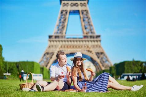 Couple Having Picnic Near The Eiffel Tower In Paris France Stock Photo