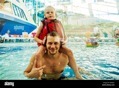Caucasian Father And Son Swimming In Pool Stock Photo Alamy