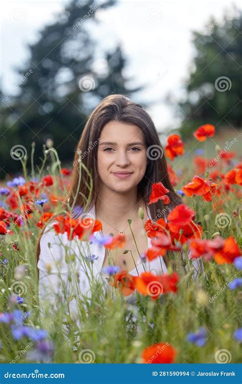Smiling Beautiful Brunette Girl Is Posing In Red Poppiesmeadow Stock