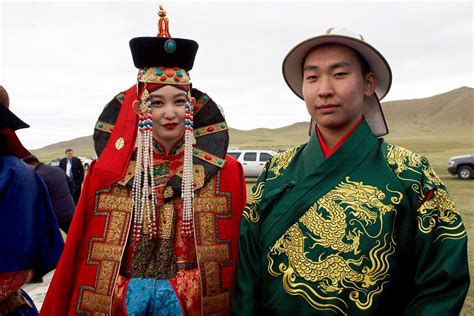 A Man And Woman In Traditional Mongolian Dress Look On As Flickr