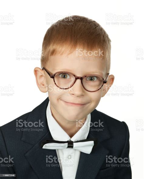 Studio Portrait Of A 7 Year Old Redhaired Boy With Glasses And In
